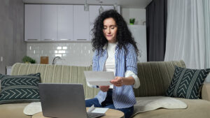 mortgage broker for defaults-Woman-Checks-Utility-Bil